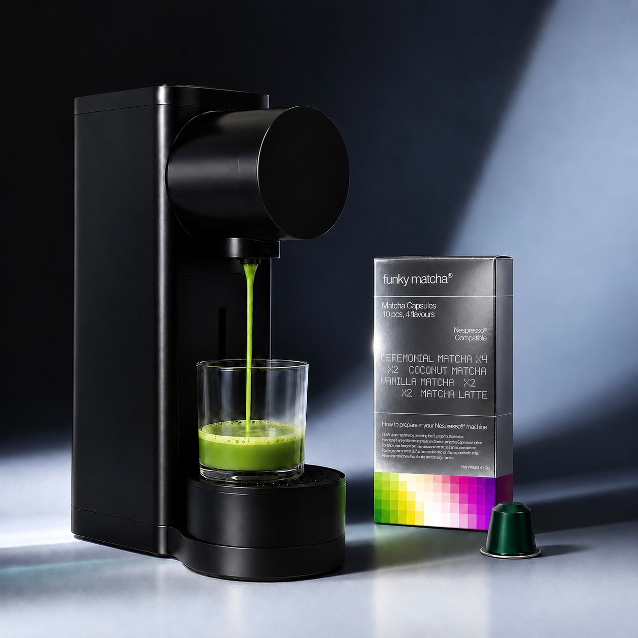 Nespresso® Original machine brewing green matcha beside the Funky Matcha Signature Selection box